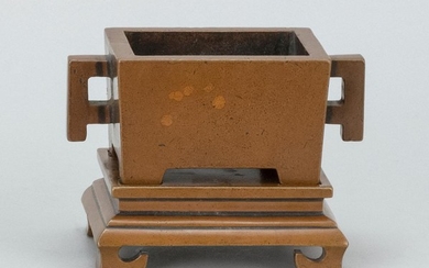 CHINESE BRONZE CENSER Rectangular, with applied handles and conforming base. Two-character mark beneath censer. Length 5.25".