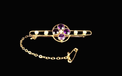 A 15 Carat Gold Bar Brooch set with a quatrefoil of amethysts and seed pearls and fitted with a safe