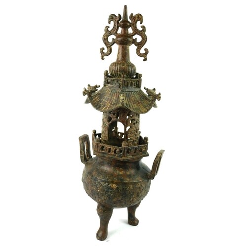 A CHINESE BRONZE CENSER Having a pierced pagoda top, with tw...