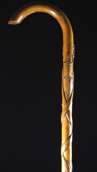 A Carved Folk Art Walking Stick decorated with reptiles with nail-punched markings; a pair of entwin
