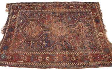 A Caucasian hand knotted wool rug, in red, blue and ivory co...