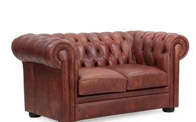 A Chesterfield two-seater with brown leather cover. Of recent manufacture. L. 165 cm.