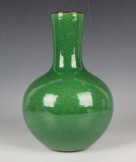 A Chinese green crackle glazed porcelain bottle vase, the globular body beneath a narrow neck and ir