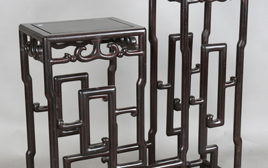 A Chinese hardwood asymmetrical stand, early 20th century, each rectangular panelled top with openwo