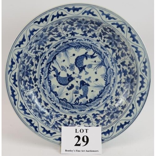 A Chinese porcelain charger with blue and white decoration a...