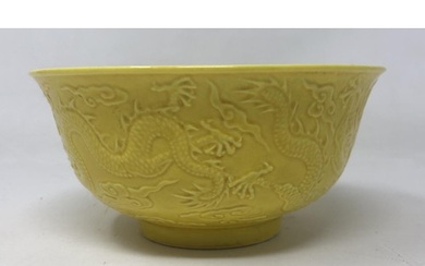 A Chinese yellow ground dragon bowl, six character mark to b...