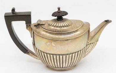 A George V silver bachelor's teapot, gadrooned lower section, ebony...