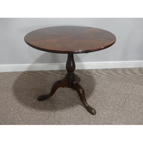 A Georgian mahogany tilt-top Tripod Table, with turned colum...