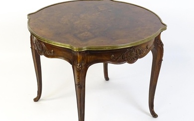 A Louis XV style centre table with a brass surround and a bu...