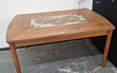 A MID CENTURY TEAK AND TILE TOP EXTENDING DINING TABLE.
