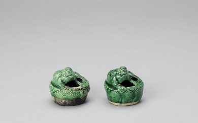 A PAIR OF EMERALD GREEN GLAZED POTTERY BUDDHIST...