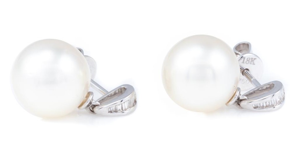 A PAIR OF SOUTH SEA PEARL AND DIAMOND STUD EARRINGS; each a 10.5mm round cultured pearl of fine colour and lustre to bale set with 7...