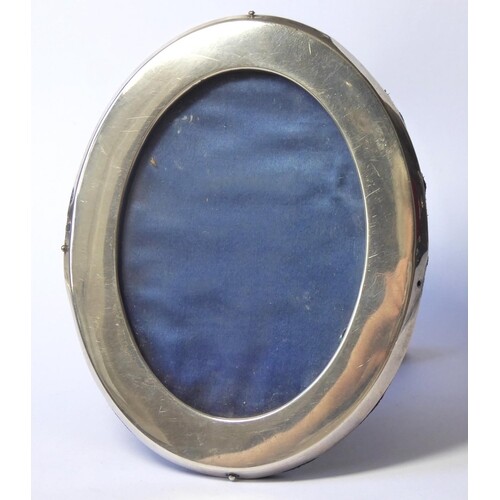 A VICTORIAN SILVER OVAL PHOTOGRAPH FRAME Plain form with eas...