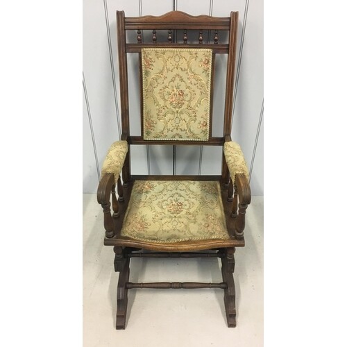 A Victorian Oak American style rocking chair. Appears to be ...