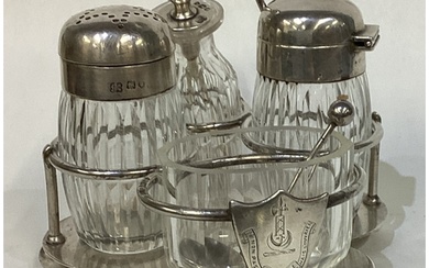 A Victorian silver cruet set on stand. London. By Hukin & He...