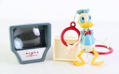A Vintage Argus previewer together wtih a small 35mm slide viewer and a vintage Donald duck hanging toy