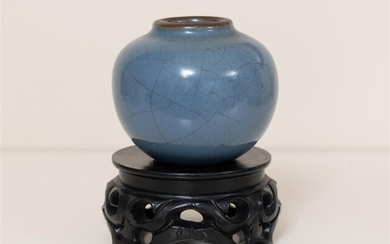 A blue crackled pottery vase raised on timber stand, vase...