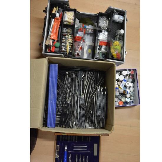 A case of model railway accessories, parts, paints and spares