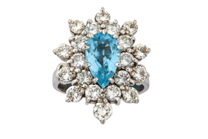 A diamond and blue topaz cluster ring The...