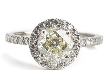 NOT SOLD. A diamond ring set with a fancy light yellow diamond weighing app. 1.76 ct. encircled by numerous brilliant-cut diamonds, mounted in 14k white gold. – Bruun Rasmussen Auctioneers of Fine Art