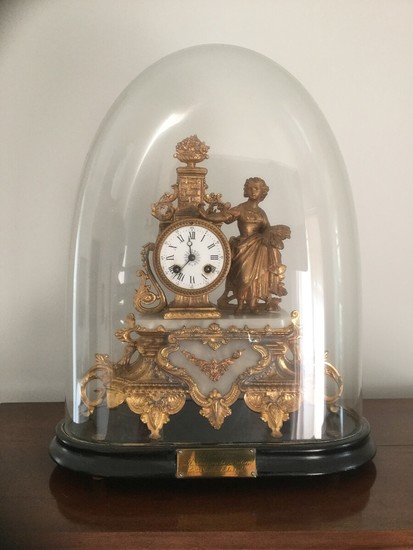 A late 19th century French gilt metal and white alabaster mantel clock. Enclosed wooden base with glass dome. H. incl. dome 53 cm. W. 40 cm.