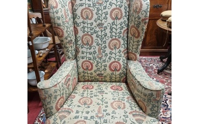 A late 19th early 20th Century wing back Armchair with cream...