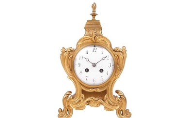 A late 19th/early 20th-century French gilt metal mantel clock, the foliate scroll form case with