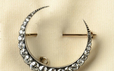 A late Victorian silver and gold old-cut diamond crescent brooch.