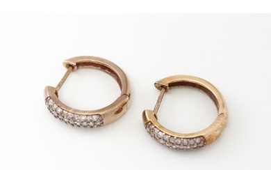 A pair of 9ct rose gold earrings set with diamonds