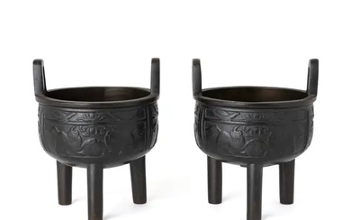 A pair of Chinese bronze tripod incense burners 18th / 19th century...