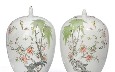 A pair of Chinese enamelled porcelain lidded jars painted with birds and...