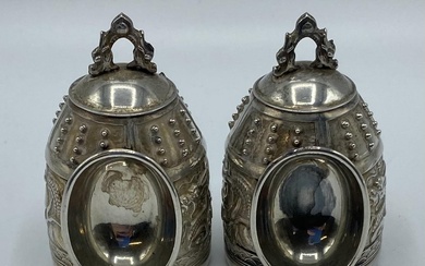 A pair of Chinese white metal ceremonial bells. Marks...