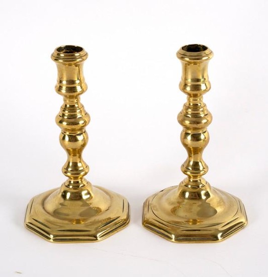 A pair of French brass candlesticks, early 18th