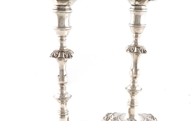 A pair of George II cast silver candlesticks