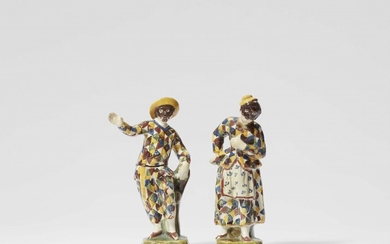 A pair of North Italian majolica figures of Arlecchino and Arlecchina