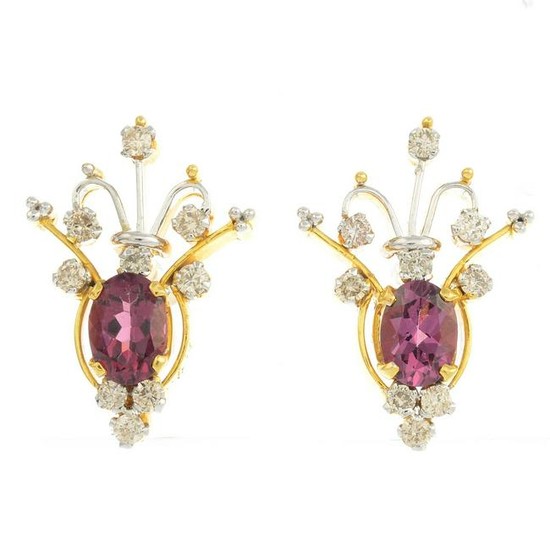 A pair of diamond and garnet earrings.Total diamond