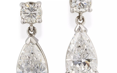 A pair of diamond drop earrings, composed of a pear...