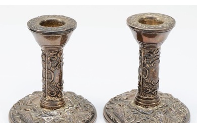 A pair of silver candlesticks, Birmingham 1973, with bird an...