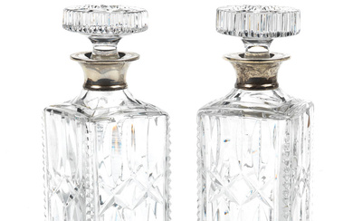 A pair of silver-topped glass decanters awarded to John Surtees...