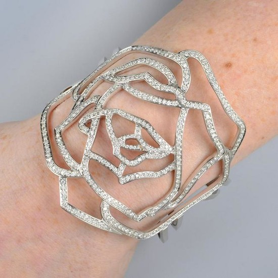 A pave-set diamond openwork rose cuff bangle, by