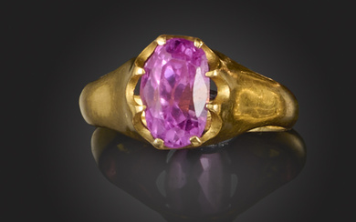 A pink sapphire ring, claw-set with an oval sapphire weighing approximately 3.00 carats