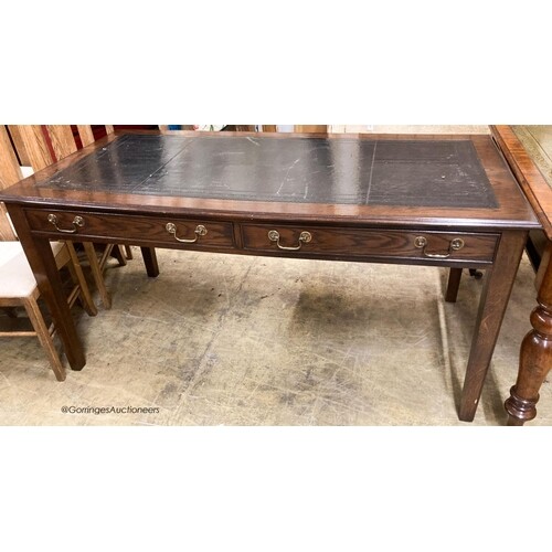 A reproduction oak two drawer writing table, W.160cm D.80cm ...