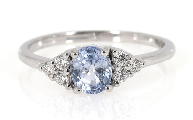A sapphire and diamond ring set with an oval-cut sapphire weighing app....