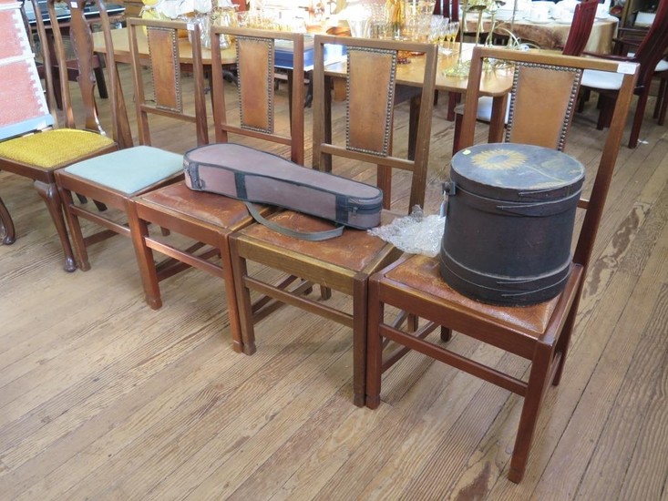 A set of four 1920s oak framed dining chairs, the top rails ...