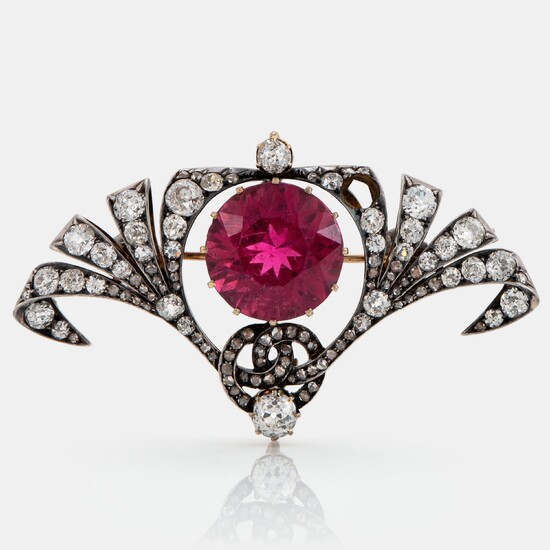 A silver and 14K gold brooch set with a faceted pink tourmaline and old- and rose-cut diamonds