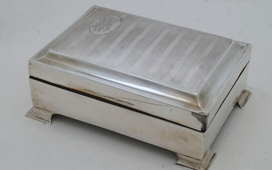 A silver cigarette box, marks rubbed, with striped engine turned cover having cartouche with monogram, wood lined, on bracket feet, 5.5cm high, 14cm wide, 10cm deep