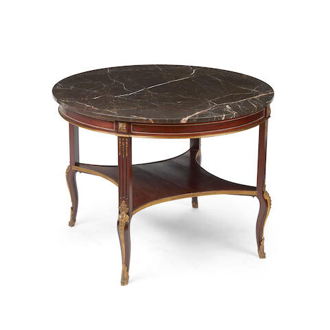 A transitional Louis XV/XVI style marble top gilt bronze mounted mahogany center table