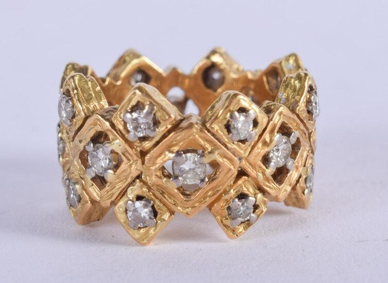 AN 18CT GOLD AND DIAMOND OPEN WORK RING. 15.4 grams.