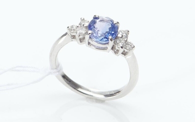 AN UNHEATED SAPPHIRE AND DIAMOND RING IN 18CT WHITE GOLD, THE OVAL CUT BLUE SAPPHIRE WEIGHING 1.51CTS, WITH DIAMOND SET SHOULDER, WI...