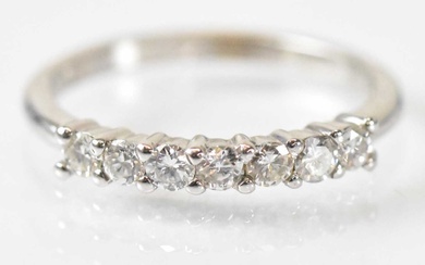An 18ct white gold seven stone diamond ring, size K/L,...
